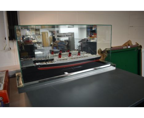 A plastic scale model of RMS Queen  in glass display case with mirrored back, case size length 73cm, height 33cm, depth 25cm