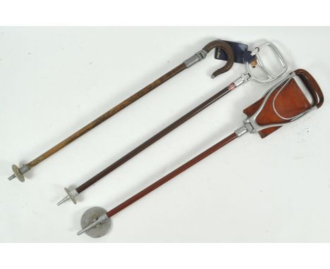 A walking stick style shooting stick, 84cm long and two other walking sticks 