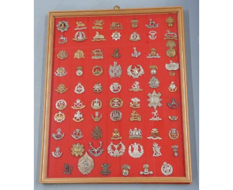 Seventy British Army cap badges including the Buffs, Suffolk Regiment, Royal Irish Regiment, Inniskilling, Border Regiment, E