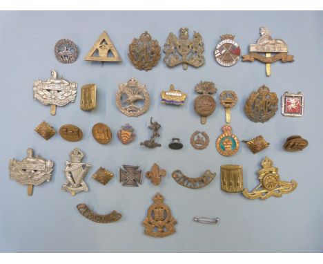 Collection of military badges including Royal Irish Rifles, Gloucestershire Regiment and Royal Artillery together with two si