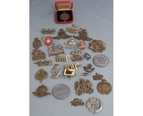 Small collection of British Army cap badges including Leinster Regiment, Tank Corps, Royal Artillery and Royal Scots together