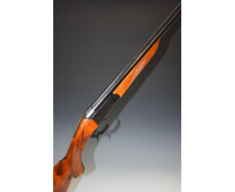 Baikal12 bore single barrelled shotgun with engraved animal scenes to the lock, chequered semi-pistol grip, sling suspension 