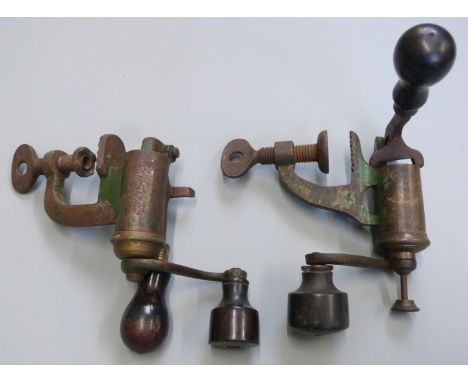 Two 12 bore shotgun cartridge re-loading&nbsp;rollover tools, both with turned wooden handles.&nbsp;