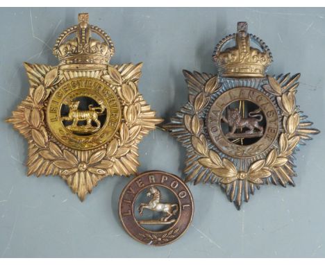 Two British Army other ranks blue cloth helmet plates for the Royal Lancaster Regiment and Leicestershire Regiment together w