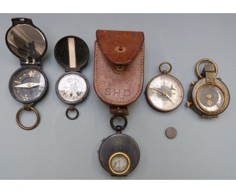 Seven military style compasses including one with a leather case marked SHD and a NEAG Berlin SO example, together with escap
