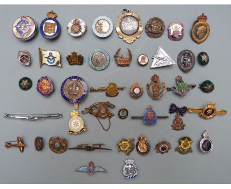 Approximately forty Armed Forces metal and enamel badges and brooches including Royal Air Force, Royal Navy, HMS Fearless, HM