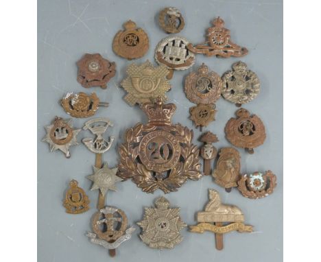 Twenty-two British Army metal badges including Middlesex Regiment, Northamptonshire Regiment, Border Regiment, Highland Light