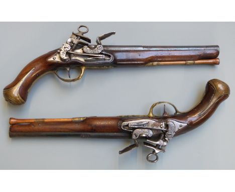 A pair of flintlock holster pistols with Miquelet locks, engraved hammers, pans and top straps, engraved brass butt plates, t