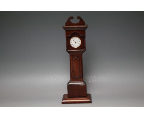 A LATE 19TH CENTURY FOLK ART CARVED WOODEN POCKET WATCH STAND IN THE FORM OF A LONGCASE CLOCK, H 35.5 cm, together with silve