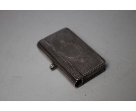 A HALLMARKED SILVER VESTA CASE IN THE FORM OF A BOOK - BIRMINGHAM 1891, makers mark J.M.R, having engine turned decoration an