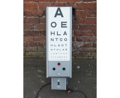 A VINTAGE WALL MOUNTED ROTATING OPTICIANS EYE SIGHT TESTING LIGHT, each panel with numerals and lettering, has fittings for i