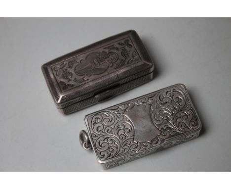 TWO SILVER VESTA CASES, the first being of snuff box form with scrolling foliate decoration and vacant cartouche, makers mark