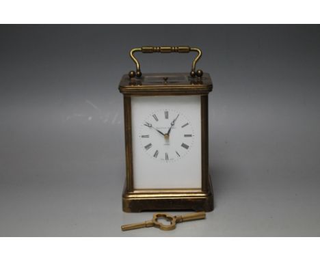 A BRASS CASED 'MATTHEW NORMAN OF LONDON' REPEATER CARRIAGE CLOCK, enamel face with Roman numerals, the brass case raised on a