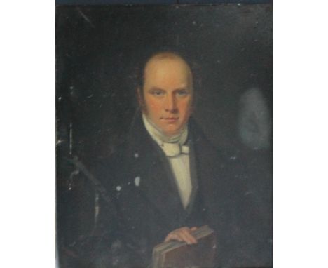 A 19TH CENTURY PORTRAIT STUDY OF A SEATED GENTLEMAN HOLDING A BOOK, unsigned, oil on panel, framed, 30 x 25 cm