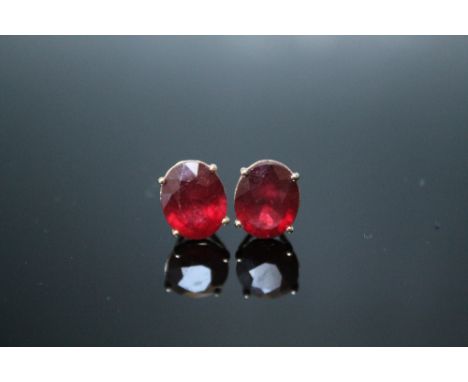 A PAIR OF 10K YELLOW GOLD RUBY EARRINGS, each oval stone measuring approx 11 mm by 8 mm