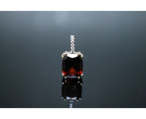 A HALLMARKED 9 CARAT GOLD RUBY PENDANT, claw set with five white stones above, approx weigh 2.8g, H 20 mm