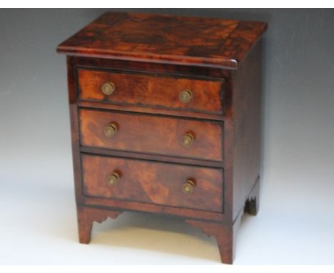 A GEORGIAN MINIATURE / APPRENTICE FLAME MAHOGANY CHEST OF THREE DRAWS, the body of the chest being mahogany, with flame mahog