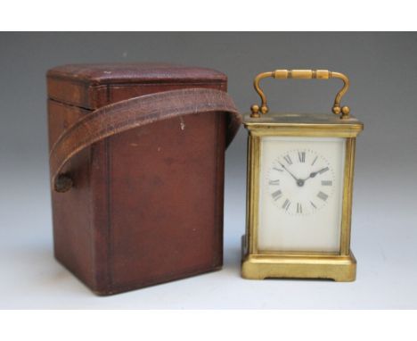 A VICTORIAN BRASS CASED CARRIAGE CLOCK IN CARRY CASE, enamel face with Roman numerals, the brass case raised on a plinth, wit