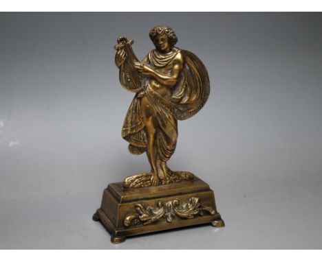 A REGENCY STYLE FIGURAL GILT POCKET WATCH STAND, in the form of a musician playing the lyre, overall H 17.5 cm