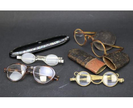 A selection of vintage spectacles. Including a hallmarked silver pair, together with three spectacle cases, one with mother o