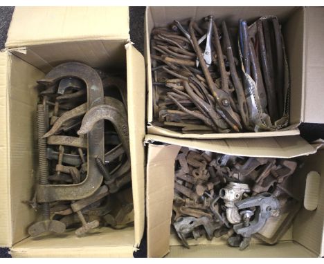 An assortment of vintage tools. Including clamps, small vices and pliers