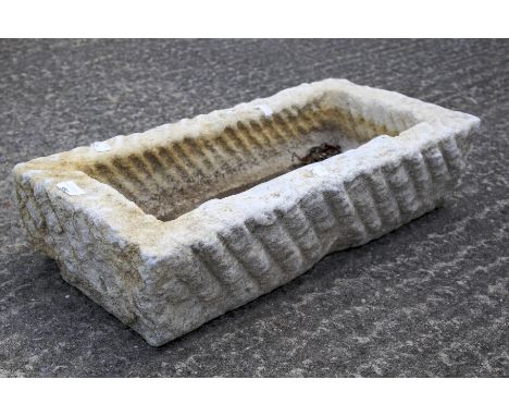 A rectangular stone garden trough with wavy textured surface. L60cm x D30cm x H15cm Condition Report: Stone is believed to be