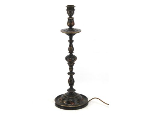 A wooden table lamp. The turned wooden structure painted black with images of Asian figures, H52cm