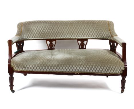 An Edwardian parlour suite comprising of a sofa and two chairs. All mahogany framed, upholstered in grey fabric and raised on