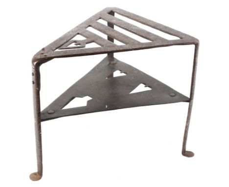 An Arts and Craft style early 20th century cast metal stand. Of triangular form with two tiers, pierced with hearts and arrow