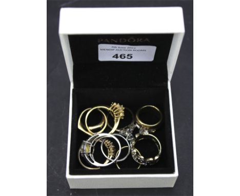 An assortment of costume dress rings. Including a 9ct gold ring and some silver