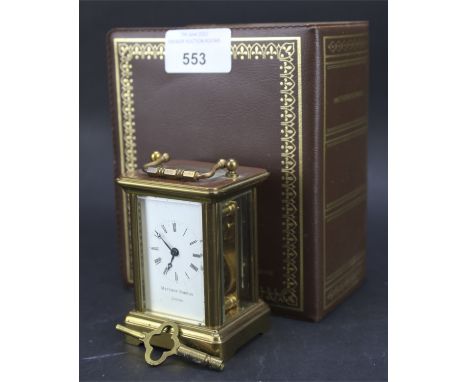 A contemporary brass cased carriage clock by Matthew Norman. The enamel dial with Roman numerals denoting hours, in original 