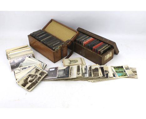 Two wooden boxes of magic lantern slides and a selection of postcards. The slides depicting artwork and landmarks, within two