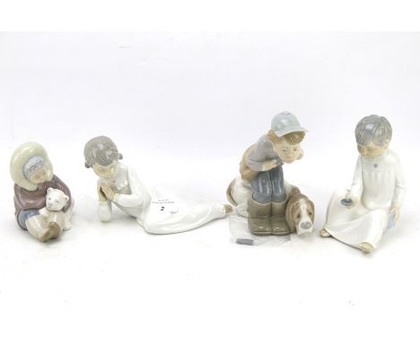 Two Lladro figures and two Nao figures. The Lladro figures of a boy with his gun dog and an Eskimo boy with a Polar Bear cub 