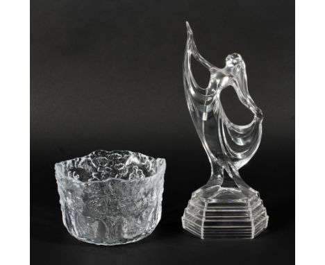 A Kosta Boda moulded glass bowl and an Art Deco style lady. Each of clear glass, the first moulded with figures dancing in wo