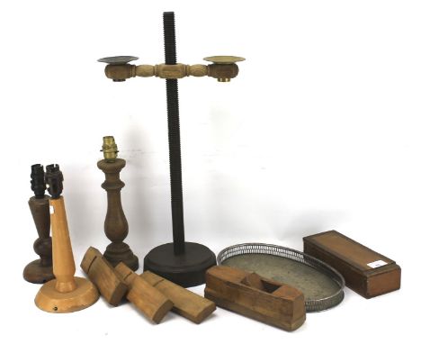 An assortment of treen. Including lamp bases, a candlestick etc, together with a pierced metal tray