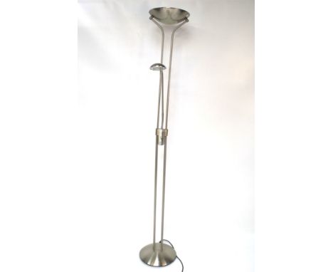 A contemporary brushed steel uplight/reading light on a round base. H183cm