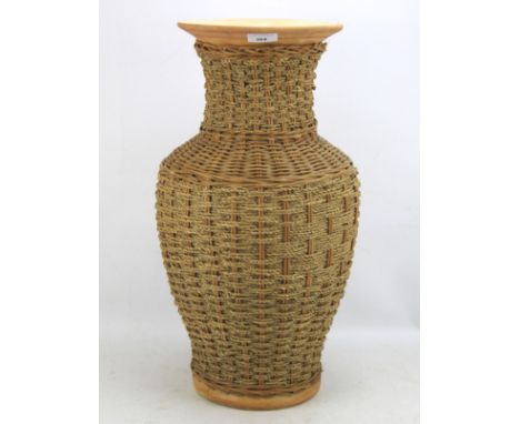 An unusual ceramic vase. The exterior covered in wicker, H53cm Condition Report: Structurally sound. Crazing to the interior 