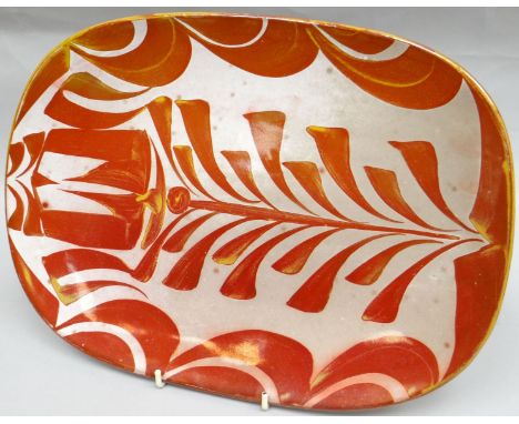 An Aldermaston studio-pottery platter by Alan Caiger-Smith, decorated in ruby and silver luster with a fern design, letter ma
