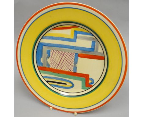 A Clarice Cliff 'Tennis' display plate in bright yellow glaze and colourful abstract interior, 9 ins diam (23 cms)