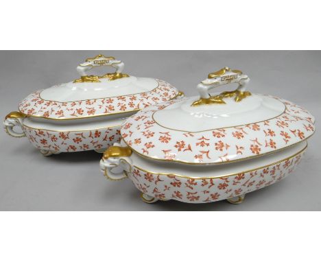 A pair of Royal Worcester footed soup-tureens of shaped oval-form profusely decorated with rust flowers and having elephant-h