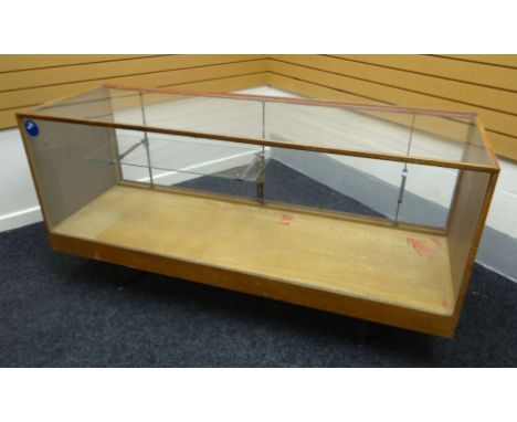A late twentieth century light wood and glass retailer's counter display raised on a metal base with corner supports, contain