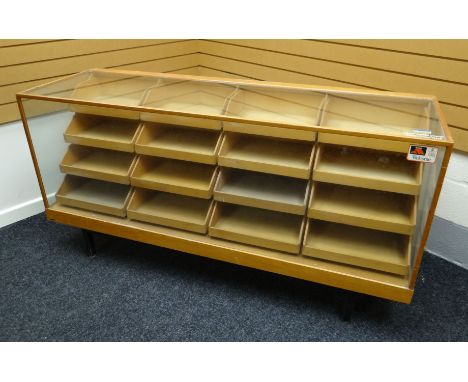 A late twentieth century light wood and glass retailer's counter display raised on a metal base with corner supports and cont