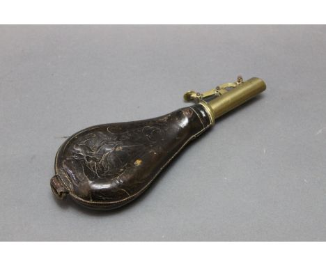 A brass and leather shot flask, the leather body embossed with hanging game, overall length 21 cm.