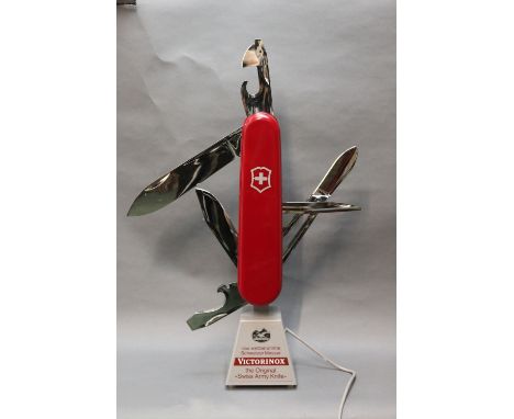 A Victorinox shop display model Swiss Army knife, electrically powered to open and shut continuously.  Height excluding blade