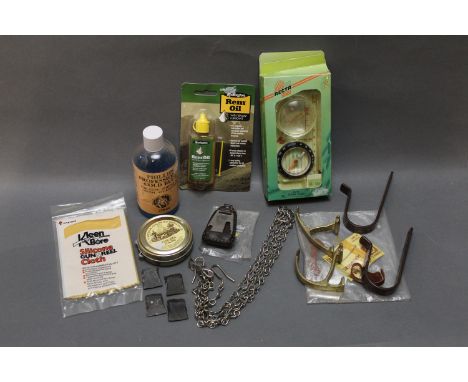 A boxed lot of Remington oil, CCL fine wax polish, gun wall hangers, flints, compass etc.