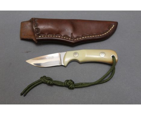 Alan Wood, a vintage fixed blade knife, having a 2½" blade with Micarta scales and brown leather sheath, engraved to the side