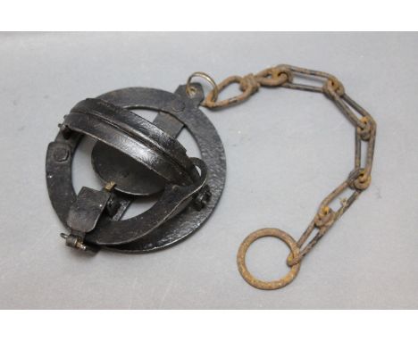 A vintage circular trap, diameter 13 cm.