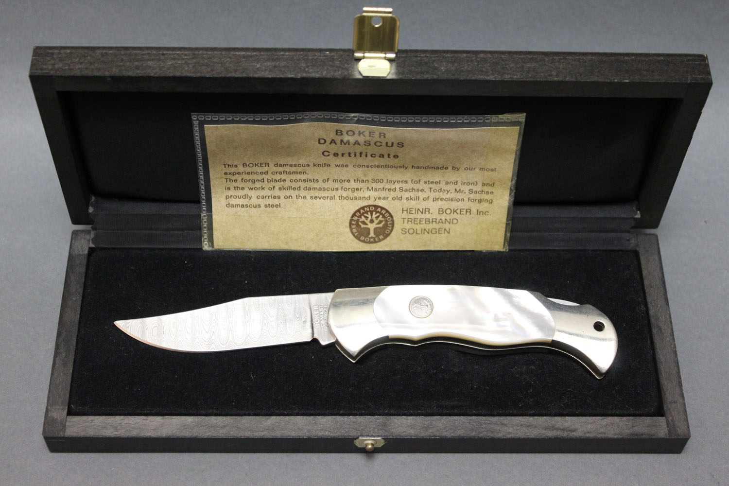 A Boker Damascus blade folding knife, with 8 cm blade, the handle with