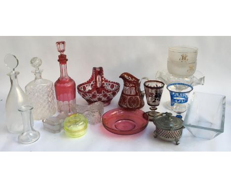 A mixed lot of glassware to include cranberry glass decanter, sweet meat basket, jug etc; various cut glass and decanters; bu