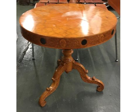 A Eastern drum table, with penwork top with carved frieze, on carved tripod base, 65cmD 